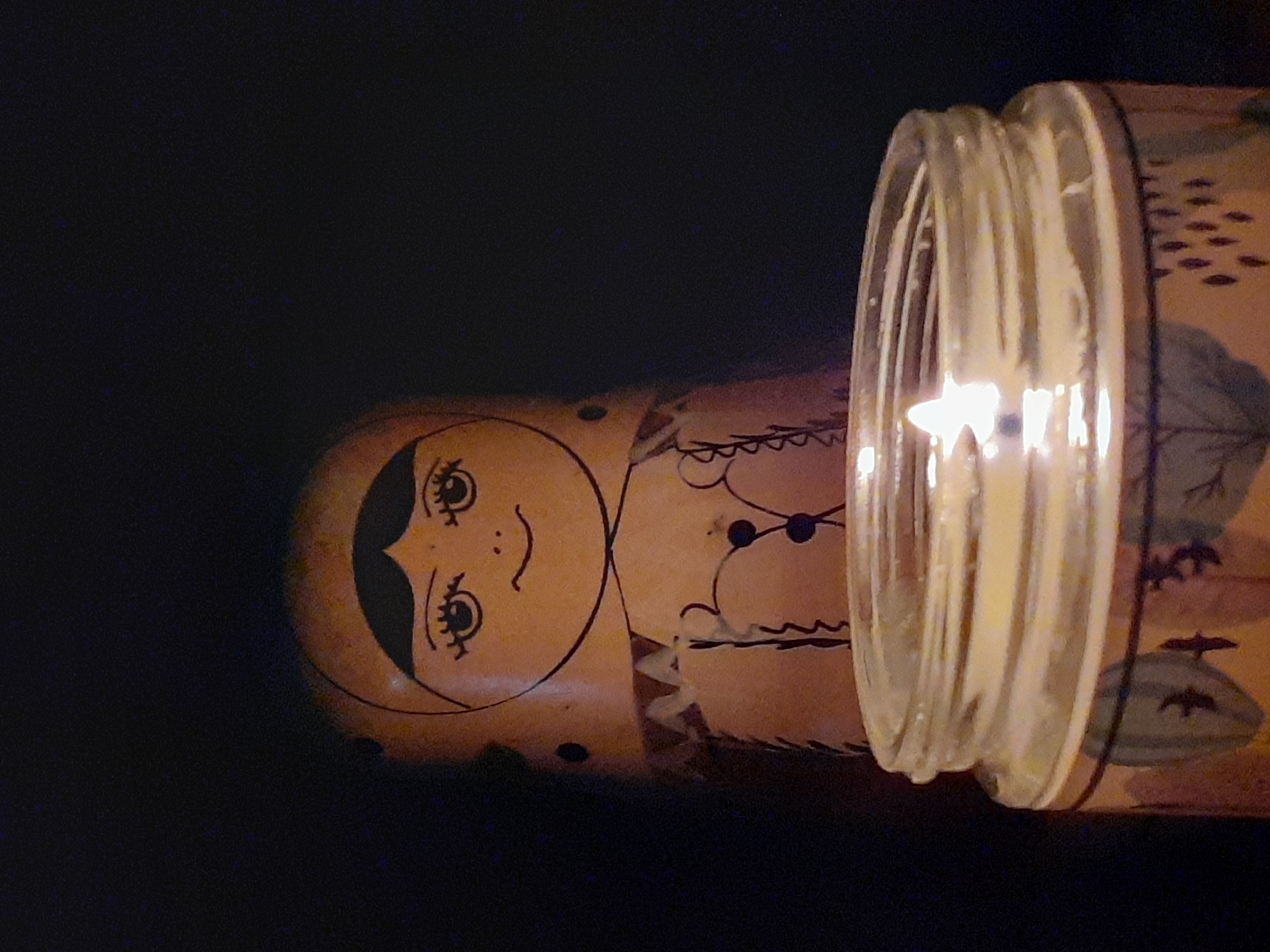 Matryoshka doll lit by candlelight